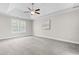 Bedroom features a ceiling fan, carpeted floors and a large window for natural light at 11124 Penderwood Ct, Raleigh, NC 27617