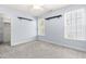 Bright bedroom featuring light blue walls, neutral carpet, and abundant natural light from two windows at 11124 Penderwood Ct, Raleigh, NC 27617
