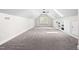 Spacious bonus room with skylights, built-in shelving, and neutral carpet, perfect for flexible living space at 11124 Penderwood Ct, Raleigh, NC 27617