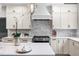 Modern kitchen with stainless steel oven, white cabinetry, white subway tile backsplash, and quartz countertops at 11124 Penderwood Ct, Raleigh, NC 27617