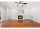 Bright living room with a fireplace, ceiling fan and hardwood flooring offers a cozy gathering space at 11124 Penderwood Ct, Raleigh, NC 27617