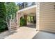 Covered outdoor patio area featuring brick columns and a staircase leading to an upper-level deck at 11124 Penderwood Ct, Raleigh, NC 27617