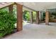 Covered patio with brick columns, offering a shady retreat with a view of the landscaped yard at 11124 Penderwood Ct, Raleigh, NC 27617