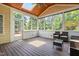 Inviting sunroom with wooden floors, a wood-paneled ceiling, and windows providing serene outdoor views at 11124 Penderwood Ct, Raleigh, NC 27617