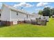 Exterior view of a backyard featuring green grass and view of the white home at 1113 Curtiss Dr, Garner, NC 27529
