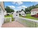 Wooden deck overlooking the backyard featuring green grass and several storage sheds at 1113 Curtiss Dr, Garner, NC 27529