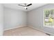 Neutral bedroom featuring a ceiling fan, one window, and carpeted floors at 1113 Curtiss Dr, Garner, NC 27529