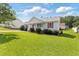 Well-maintained home featuring a green lawn and tidy landscaping in a quiet neighborhood at 1113 Curtiss Dr, Garner, NC 27529
