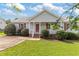 Charming single-story home featuring a well-manicured lawn and a cozy front porch with red shutters at 1113 Curtiss Dr, Garner, NC 27529