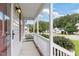 Side view of the front porch featuring white railings and views of the neighborhood at 1113 Curtiss Dr, Garner, NC 27529