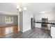 Modern kitchen with white cabinets, stainless steel appliances, and stylish backsplash adjacent to the dining area at 1113 Curtiss Dr, Garner, NC 27529
