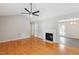 Open-concept living room with hardwood floors, fireplace, and doorways leading to other rooms at 1113 Curtiss Dr, Garner, NC 27529