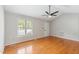 Bright living room featuring hardwood floors, a ceiling fan, and ample natural light from a window at 1113 Curtiss Dr, Garner, NC 27529