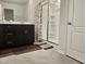 Bathroom featuring a dark vanity, framed mirror, and a glass-enclosed shower at 112 Wilbur Lake Dr, Fuquay Varina, NC 27526