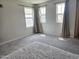 Empty carpeted bedroom featuring big windows and curtains at 112 Wilbur Lake Dr, Fuquay Varina, NC 27526
