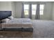 Large carpeted bedroom with big windows and curtains showing a comfortable interior space at 112 Wilbur Lake Dr, Fuquay Varina, NC 27526