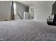 Upstairs bonus room with carpeting, window and view into adjacent bedroom at 112 Wilbur Lake Dr, Fuquay Varina, NC 27526