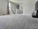 Upstairs bonus room with carpeting and view into adjacent bedroom at 112 Wilbur Lake Dr, Fuquay Varina, NC 27526
