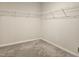 Empty carpeted walk-in closet with wire shelving at 112 Wilbur Lake Dr, Fuquay Varina, NC 27526
