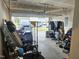 Garage interior with an open door, storage, and parked cars outside at 112 Wilbur Lake Dr, Fuquay Varina, NC 27526