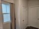 Hallway area with window, neutral paint and classic doors at 112 Wilbur Lake Dr, Fuquay Varina, NC 27526