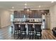 Kitchen island with brown cabinets, stainless steel appliances, and seating at 112 Wilbur Lake Dr, Fuquay Varina, NC 27526