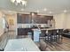 Open-concept kitchen with island, dark cabinets, and stainless appliances at 112 Wilbur Lake Dr, Fuquay Varina, NC 27526