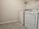 Laundry area featuring a white front-load washer and dryer at 112 Wilbur Lake Dr, Fuquay Varina, NC 27526
