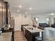 Open-concept living area with kitchen island, casual seating, and living spaces at 112 Wilbur Lake Dr, Fuquay Varina, NC 27526