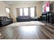 Living room with plush sofas, large windows, and modern entertainment center at 112 Wilbur Lake Dr, Fuquay Varina, NC 27526