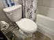 Close-up view of a standard toilet in a bathroom with neutral tiling at 112 Wilbur Lake Dr, Fuquay Varina, NC 27526