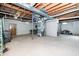 Unfinished basement space with exposed ceiling, concrete floor, and utility access at 1128 E Geer St, Durham, NC 27704