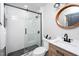 Modern bathroom features a glass shower, white subway tiles, and black accents at 1128 E Geer St, Durham, NC 27704