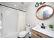 Bathroom features a tub/shower combo, modern vanity and fixtures, and recessed lighting at 1128 E Geer St, Durham, NC 27704