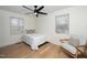 Bright bedroom with hardwood floors, white walls, a ceiling fan and a relaxing chair at 1128 E Geer St, Durham, NC 27704