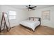 Bright bedroom with light hardwood floors, white walls, and a modern ceiling fan at 1128 E Geer St, Durham, NC 27704