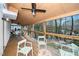 Covered wood deck featuring views of a wooded area and a ceiling fan at 1128 E Geer St, Durham, NC 27704