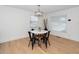 Bright dining area with a modern round table, complemented by natural light and wood flooring at 1128 E Geer St, Durham, NC 27704