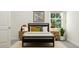 Comfortable bedroom featuring a black platform bed, two side tables, accent lamps, and a bright window at 1248 Coral Cay Bnd, Wake Forest, NC 27587