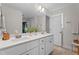 Modern bathroom featuring double vanity sinks with white countertops and framed mirror at 12658 W Hanes Ave, Middlesex, NC 27557