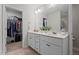 Bright bathroom features a double vanity with closet in the background at 12658 W Hanes Ave, Middlesex, NC 27557