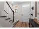 Inviting entryway with wood floors, staircase, and charming decor at 12658 W Hanes Ave, Middlesex, NC 27557