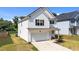 Charming two-story home with white siding, black shutters, attached garage, and well-maintained lawn at 12658 W Hanes Ave, Middlesex, NC 27557
