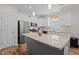 Well-lit kitchen featuring stainless steel appliances, granite counters, and a convenient center island at 12658 W Hanes Ave, Middlesex, NC 27557