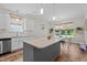 Kitchen with island, granite countertops, stainless dishwasher, and a view to the dining area at 12658 W Hanes Ave, Middlesex, NC 27557