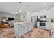 Modern kitchen boasts stainless steel appliances, granite counters, and a central island open to the living room at 12658 W Hanes Ave, Middlesex, NC 27557