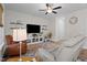 Bright living room with leather recliner, soft gray couch, ceiling fan and entertainment center at 12658 W Hanes Ave, Middlesex, NC 27557