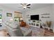 Cozy living room with comfortable seating, natural light, ceiling fan, and stylish decor at 12658 W Hanes Ave, Middlesex, NC 27557