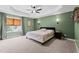 Spacious main bedroom with tray ceiling, ceiling fan, and plenty of natural light at 12658 W Hanes Ave, Middlesex, NC 27557