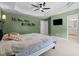 Spacious main bedroom with tray ceiling, ceiling fan, and direct access to the en-suite bathroom at 12658 W Hanes Ave, Middlesex, NC 27557